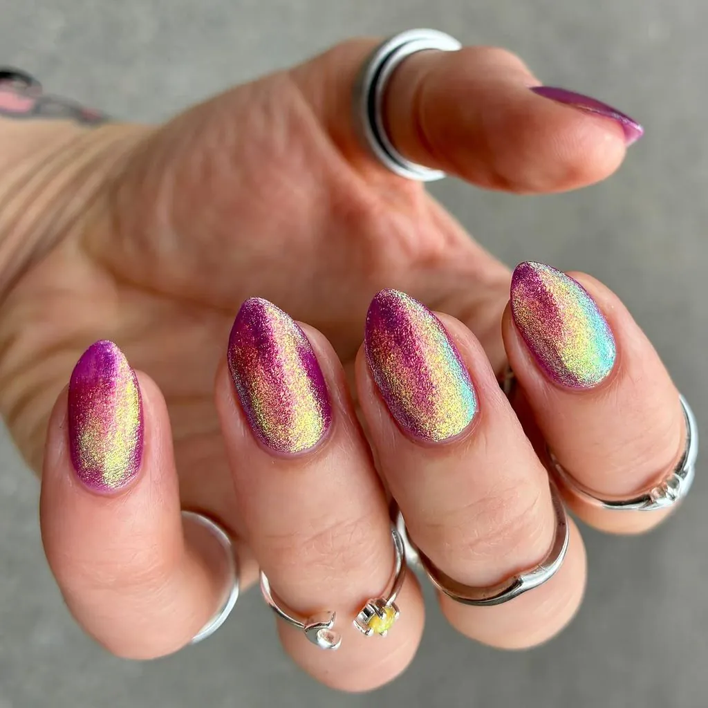oval almond nails with purple and gold iridescent glitter magnetic chrome finish