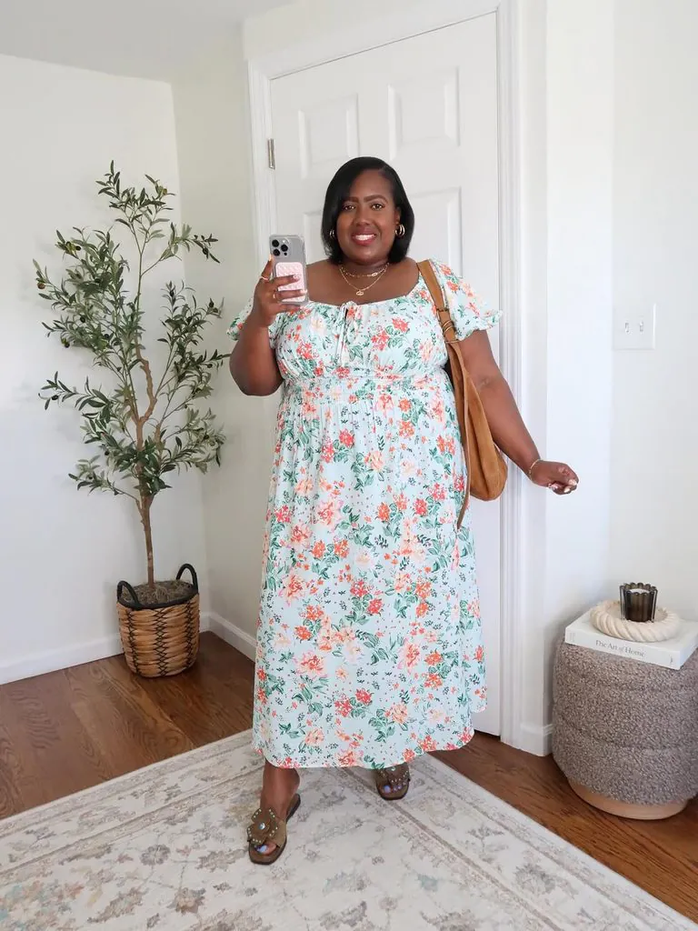 plus size woman wearing a floral print maxi dress indoors