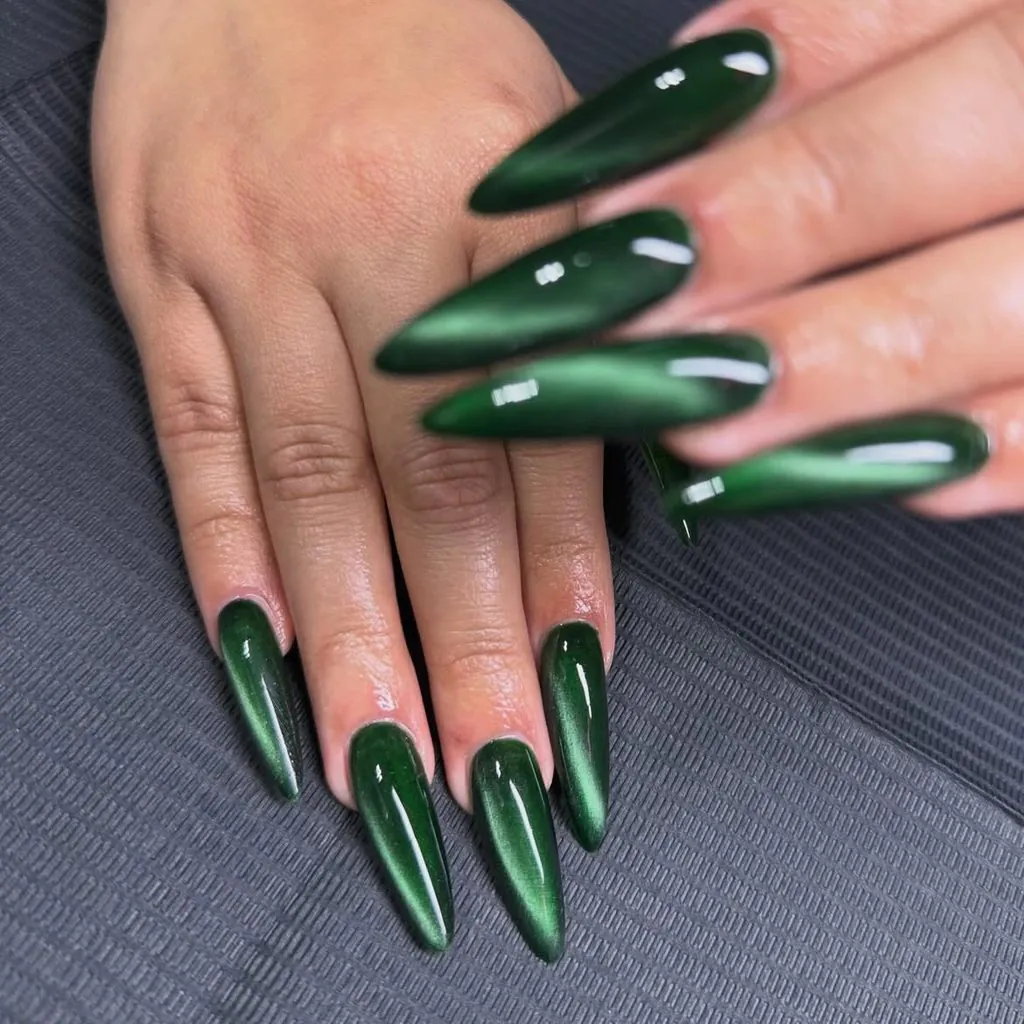 long glossy dark emerald green cat eye stiletto nails