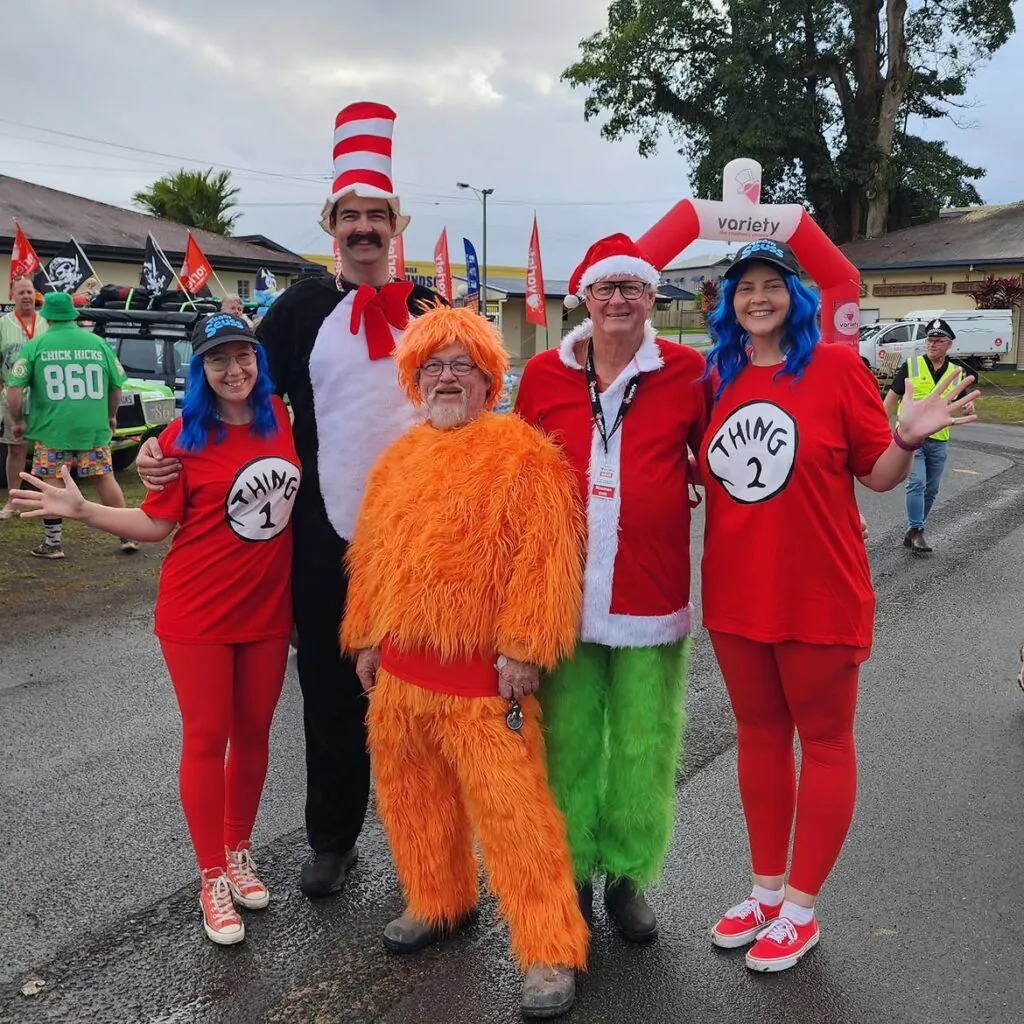 family wearing Dr. Seuss costumes posing outdoors