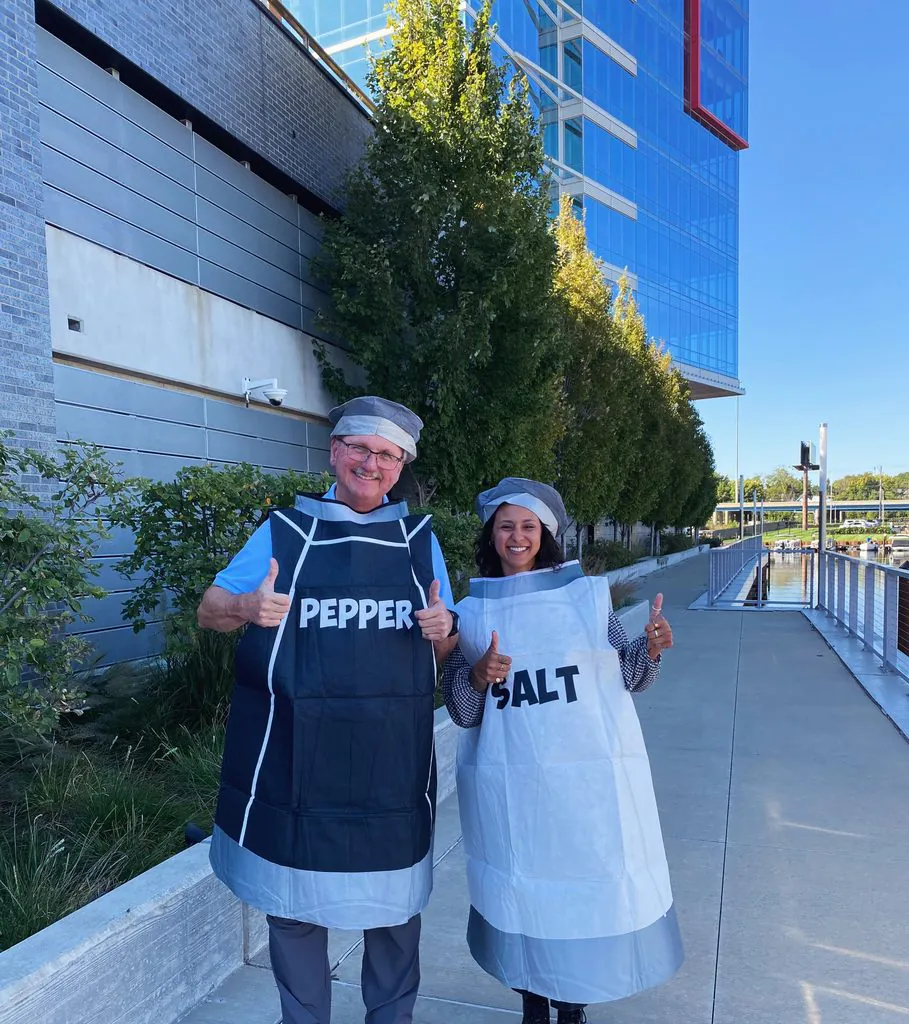 couple wearing salt and pepper shaker halloween costumes smiling and giving thumbs up