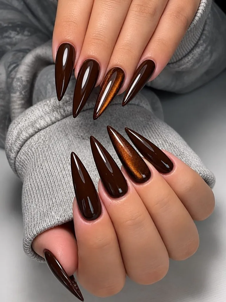 glossy dark brown stiletto nails with copper cat eye shimmer accent nails